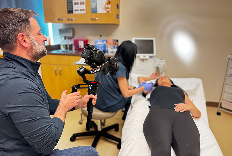 Professional videographer capturing video content at dermatology clinic