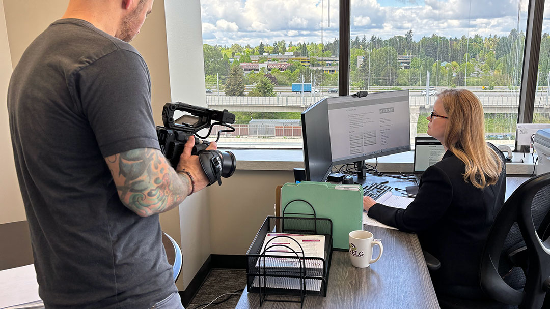 Professional videographer capturing video content at an office in Seattle