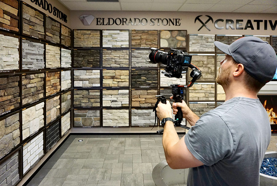 Videographer capturing video content in construction materials showroom