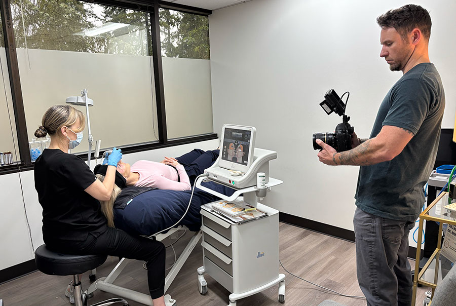 Professional videographer shooting procedure in dermatology clinic