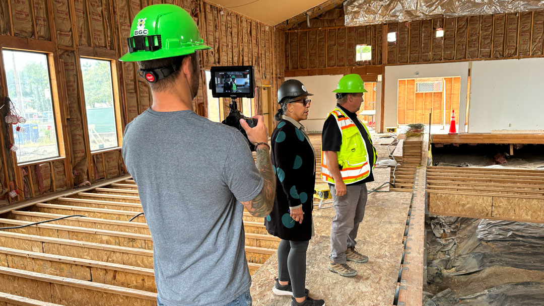 Professional videographer filming video content on a construction site